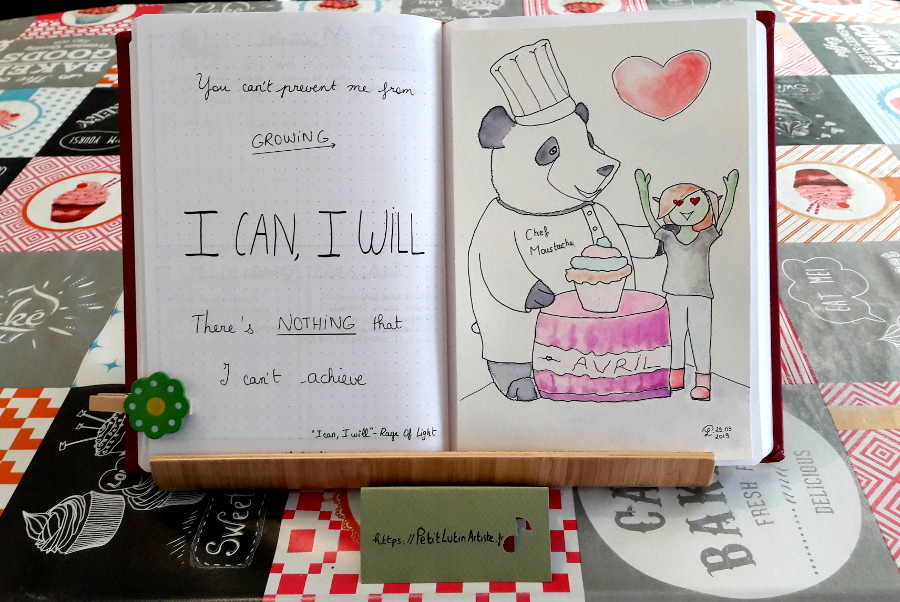 Belette Journal, mon bullet journal d'avril 2019, page de gauche le refrain de 'I can I will' de Rage of Fire, à droite une aquarelle avec Moustache le panda qui est habillé en chef cuisinier et qui a fait un cupcake géant pour Petit Lutin qui est ravie