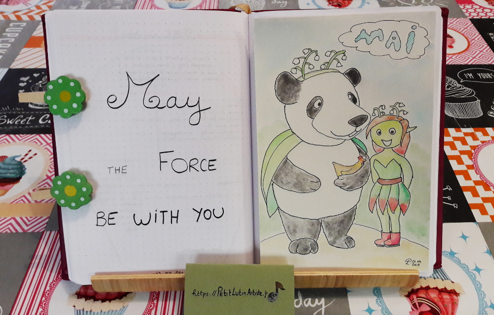 Belette Journal, mon bullet journal de mai 2019, page de gauche j'ai écrit 'May the force be with you', et à droite Moustache le panda et Petit Lutin ont du muguet dans les cheveux en guise d'antennes.