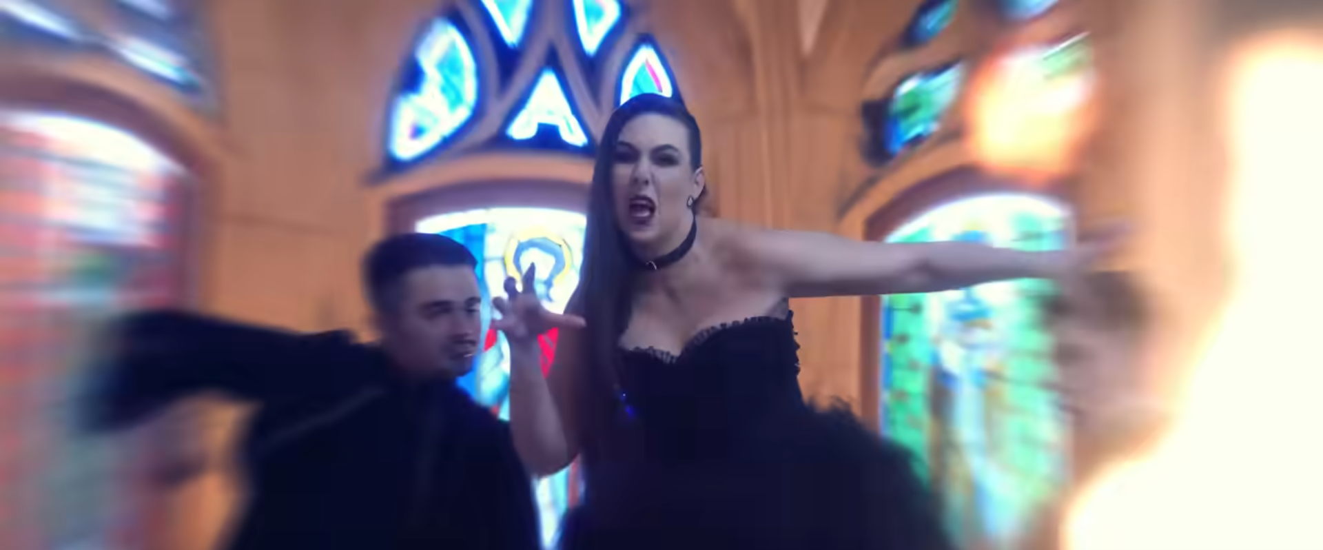 screenshot of the clip Damnation Flame, with the singer on foreground